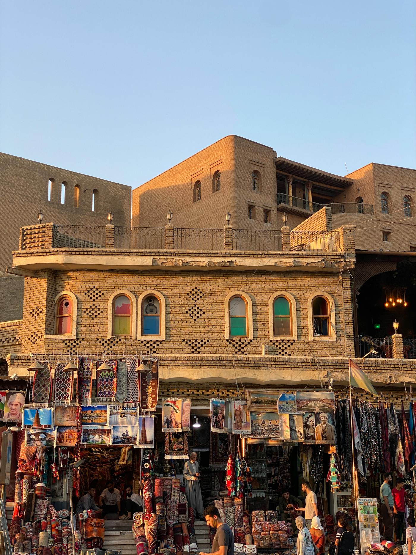 Historic Erbil Citadel and market stalls at sunset